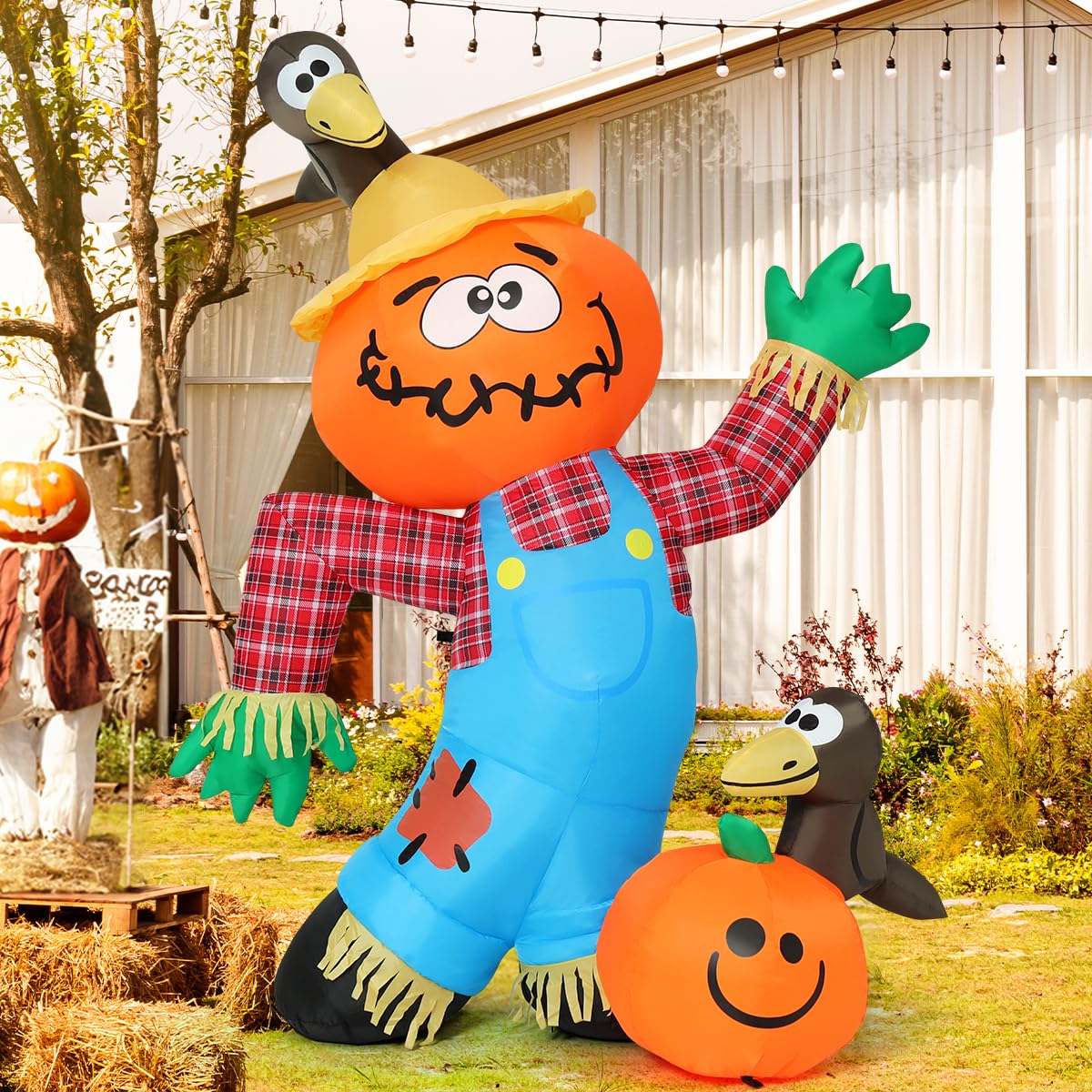 COMIN scarecrow staked in lawn showing secure weatherproof setup