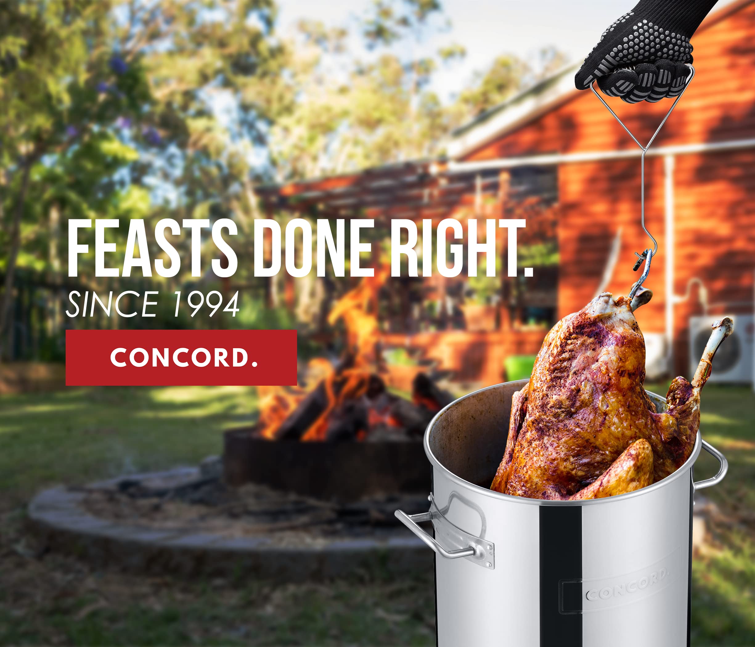 Concord turkey being lowered into pot demonstrating safer frying process