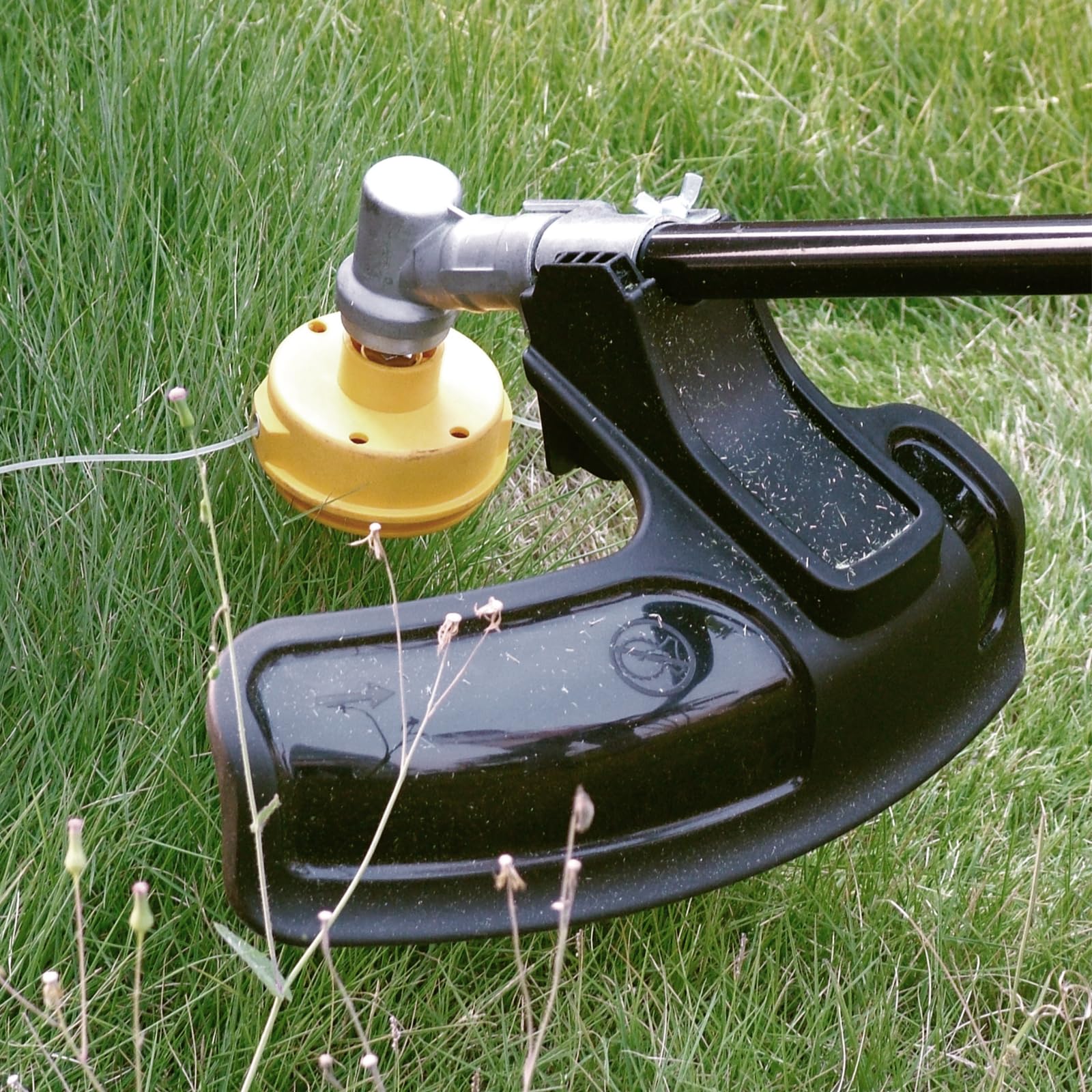 COPLAR attachment installed on powerhead trimming grass, speeds yard work