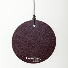 Corinthian Bells hanging on a porch in plum, enhancing outdoor ambience and visual appeal