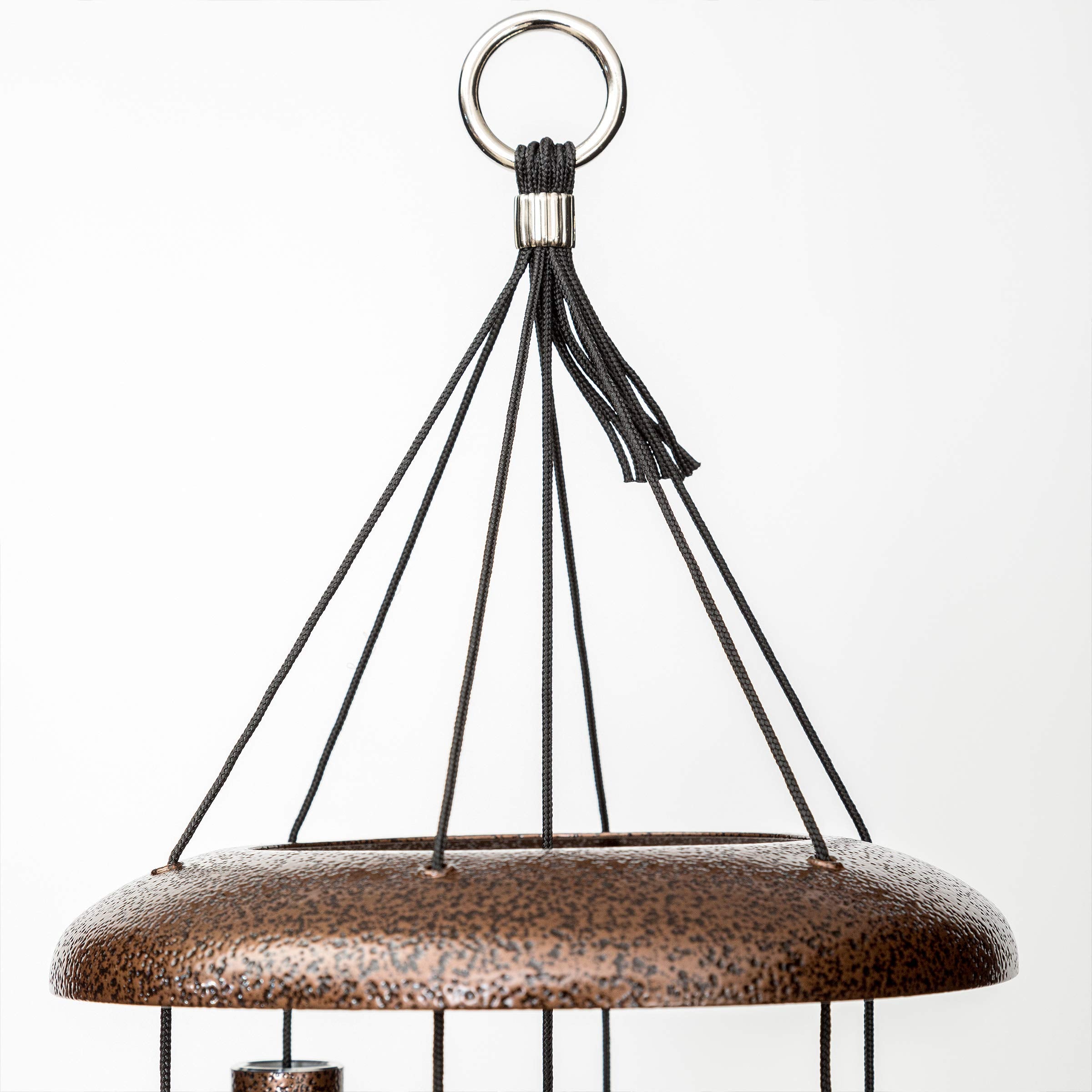Corinthian Bells next to chair showing size scale and appropriate outdoor fit benefit