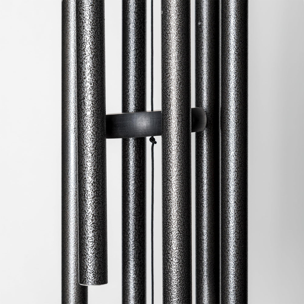 Corinthian Bells next to chair showing 30 inch overall length and scale