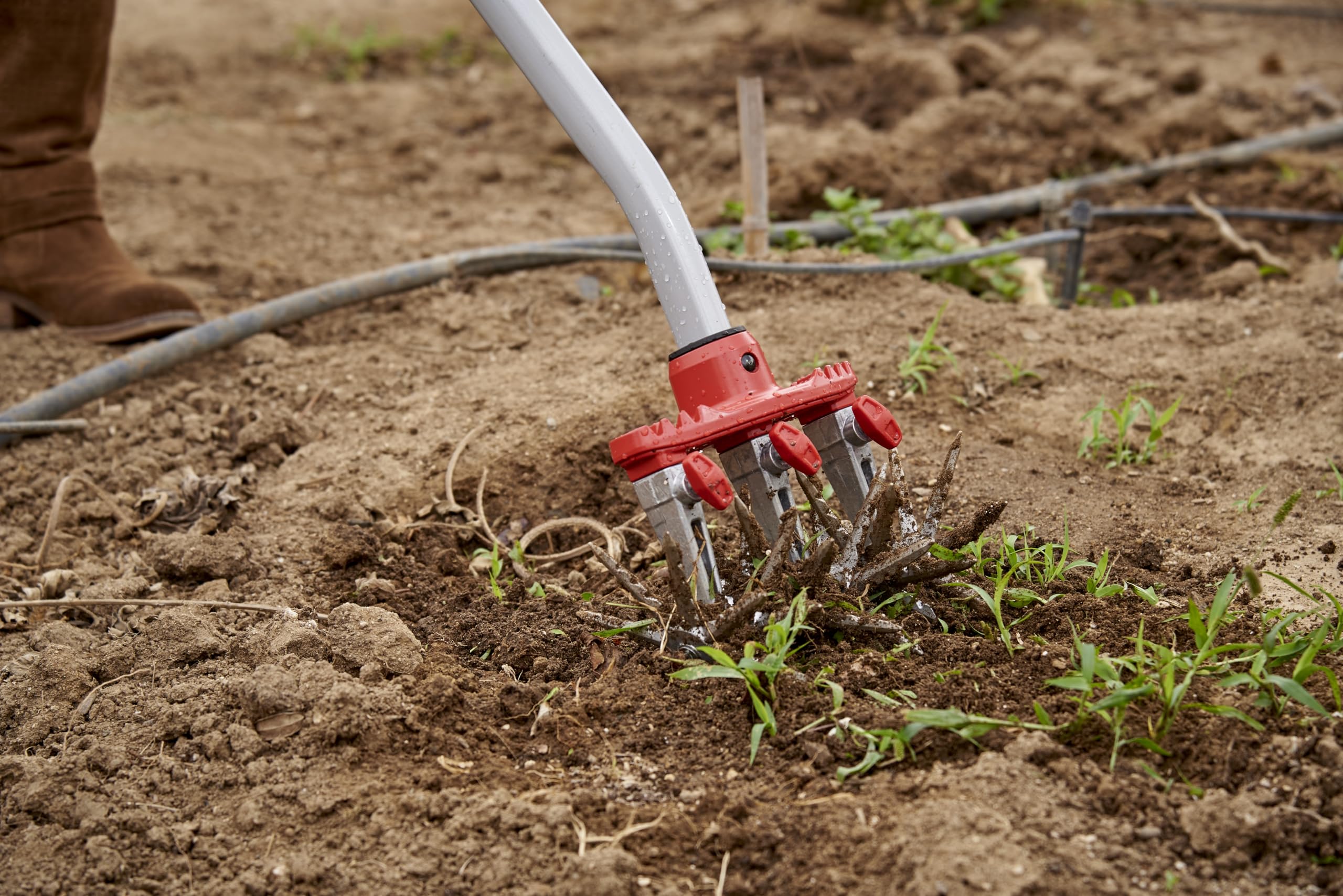 Corona Clipper cultivator in use on garden bed demonstrating efficient soil turnover