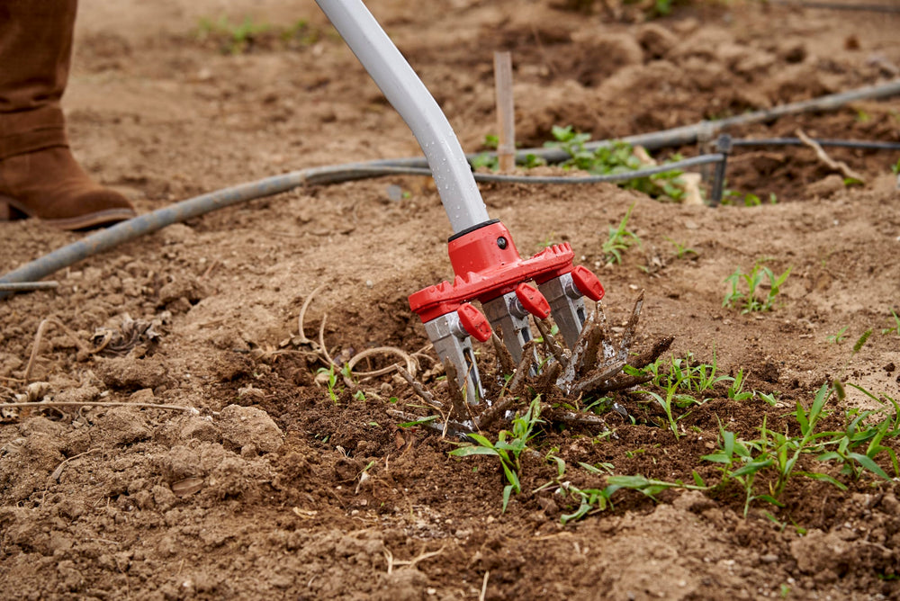 Corona Clipper cultivator in use on garden bed demonstrating efficient soil turnover