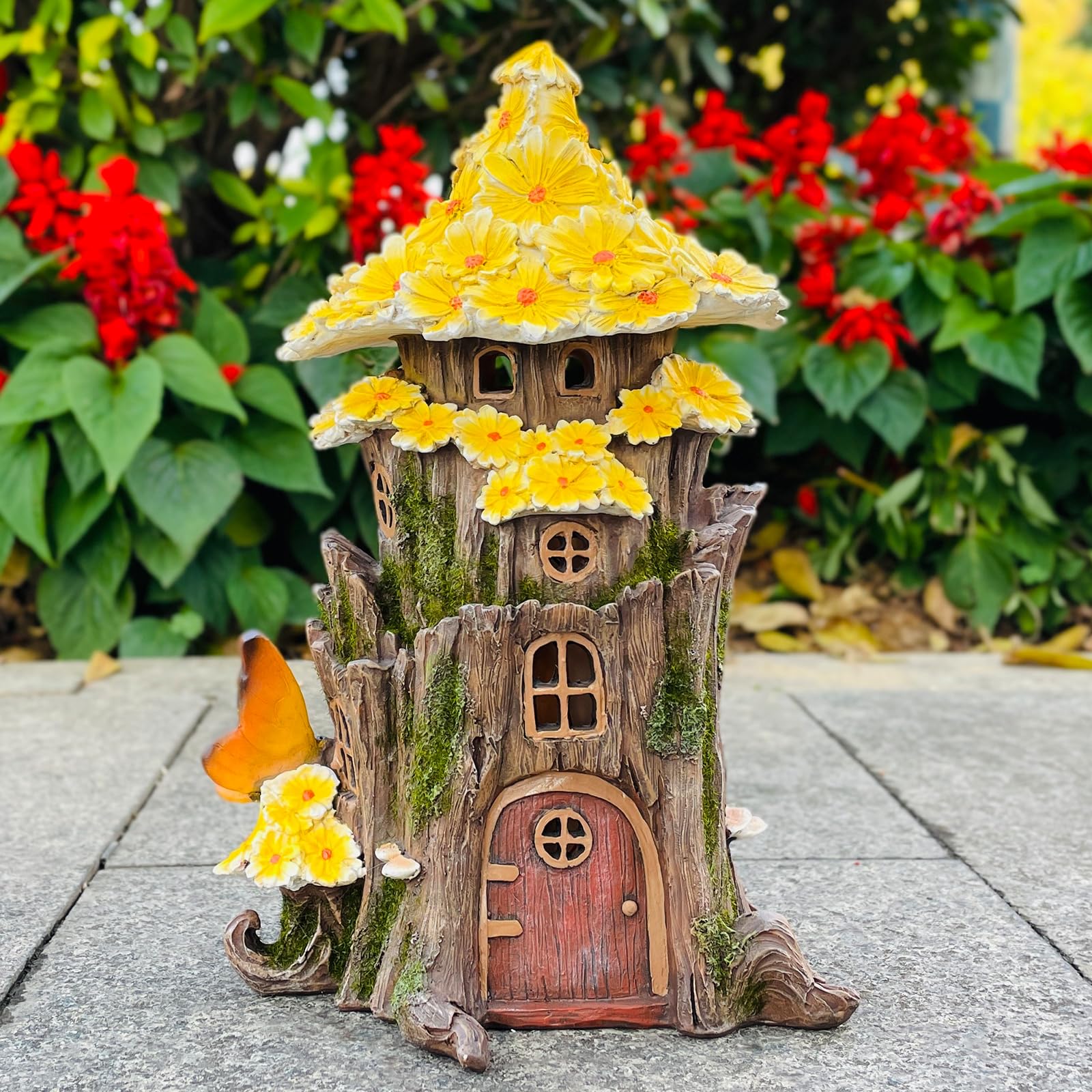 COWOS fairy house nestled in a flower bed enhancing garden mood lighting