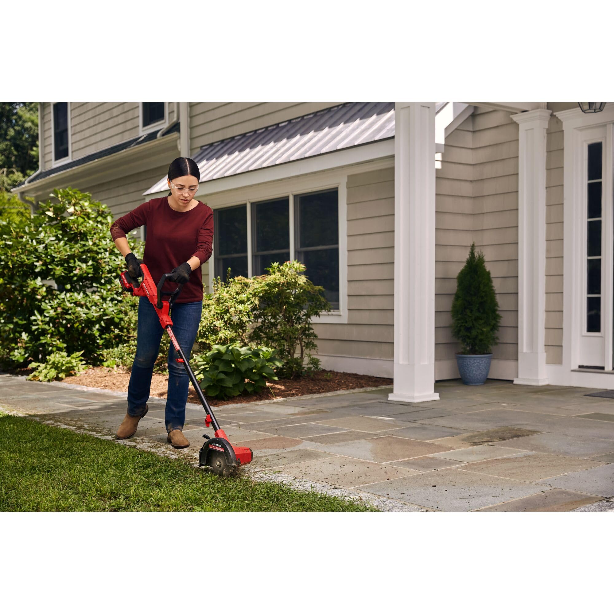 CRAFTSMAN edger being carried to yard showing portable, lightweight benefit