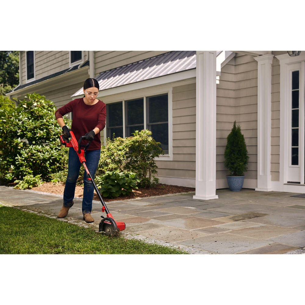 CRAFTSMAN edger being carried to yard showing portable, lightweight benefit