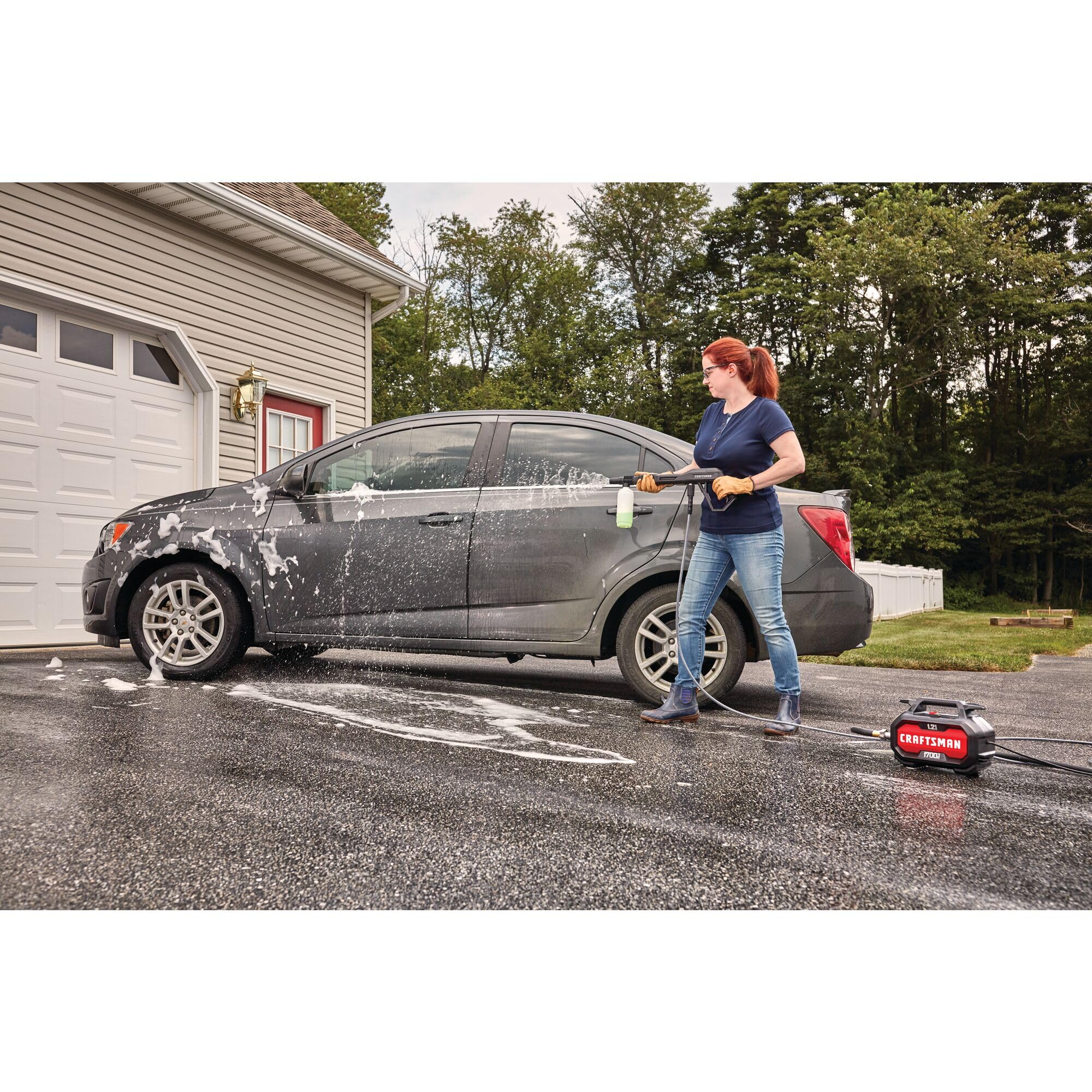 CRAFTSMAN in use washing a car and driveway demonstrating effective exterior cleaning