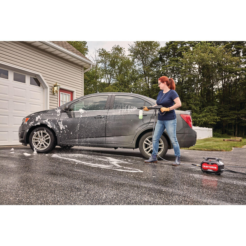 CRAFTSMAN in use washing a car and driveway demonstrating effective exterior cleaning