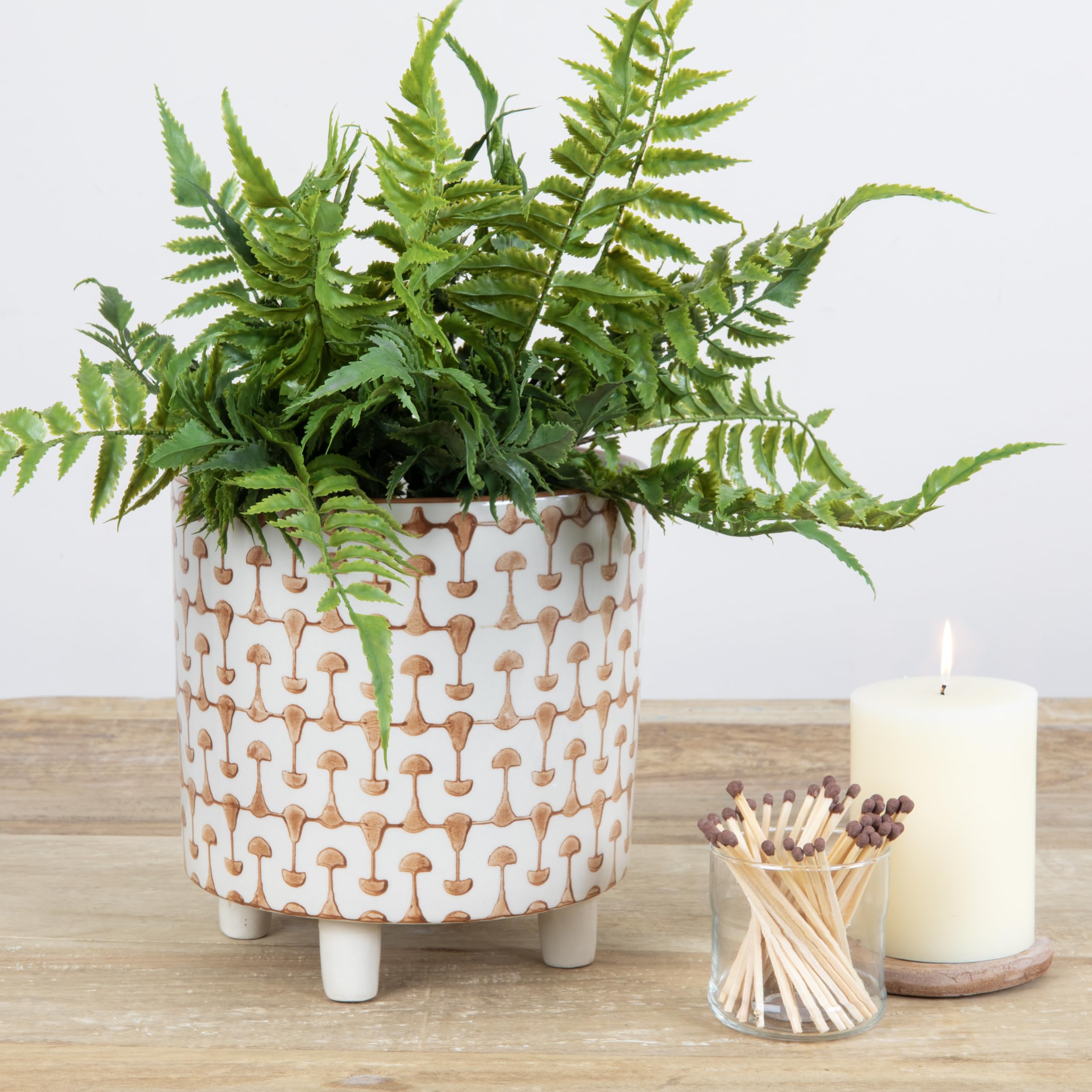 Creative Co-Op planter styled on a shelf with books and decor, creates curated greenery vignette