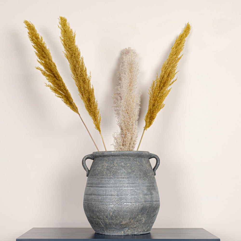 Creative Co-Op urn on patio creating cohesive outdoor focal point