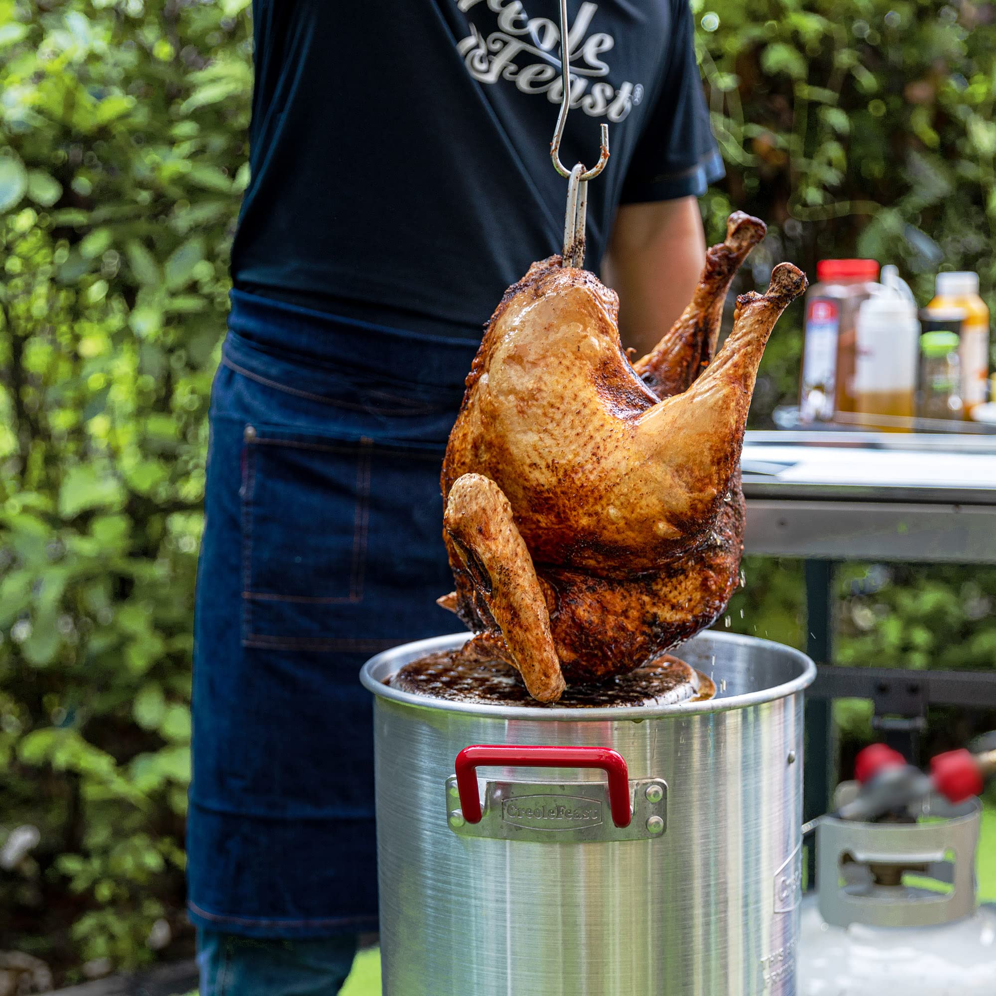 Creole Feast fryer in backyard cookout scene for festive outdoor meal preparation