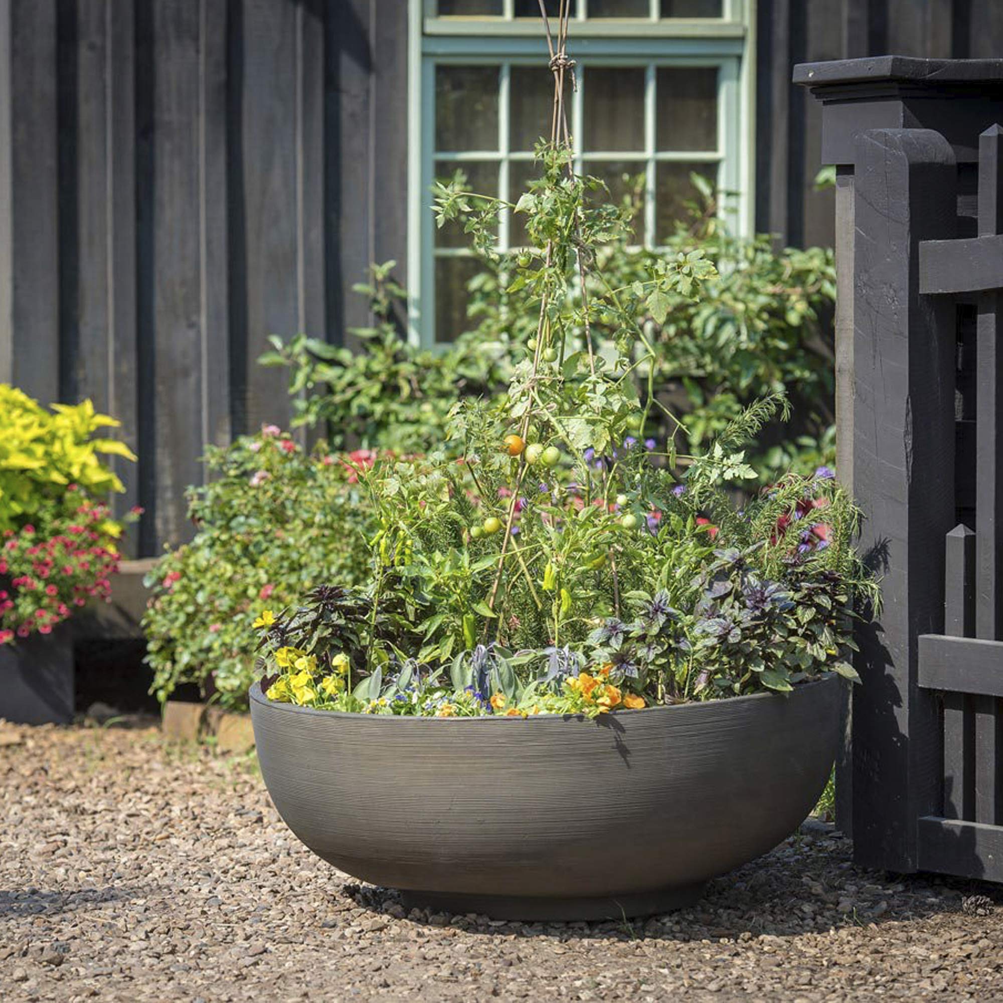 Crescent Garden Orinoco next to hands demonstrating lightweight portability and easy repositioning