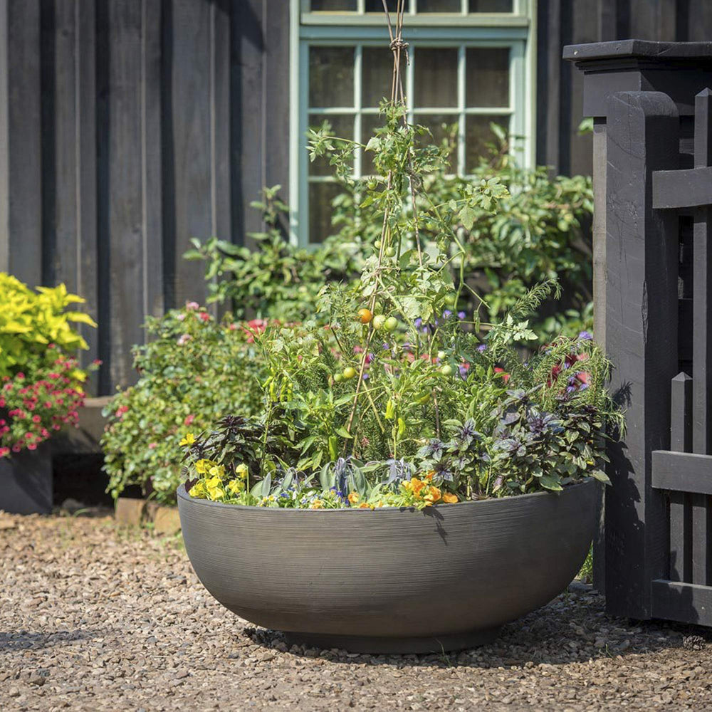 Crescent Garden Orinoco next to hands demonstrating lightweight portability and easy repositioning