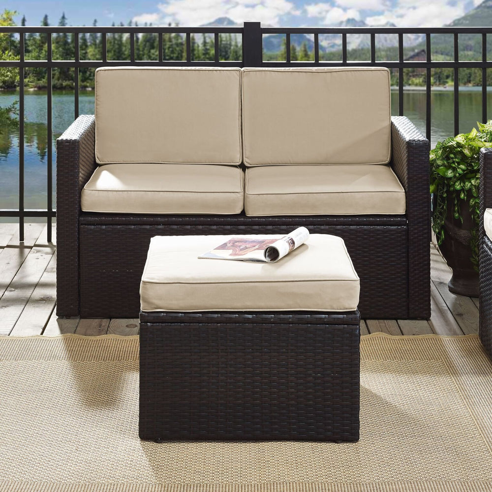 Crosley Palm Harbor ottoman next to chair showing scale and modular pairing