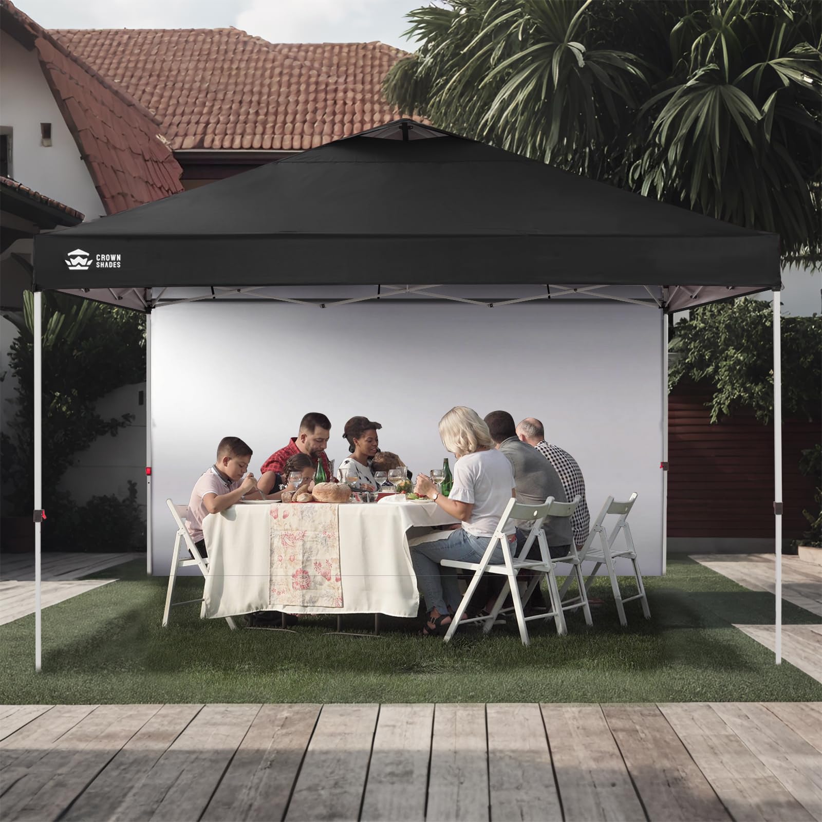 CROWN SHADES sidewall in backyard gathering creating private, shaded space