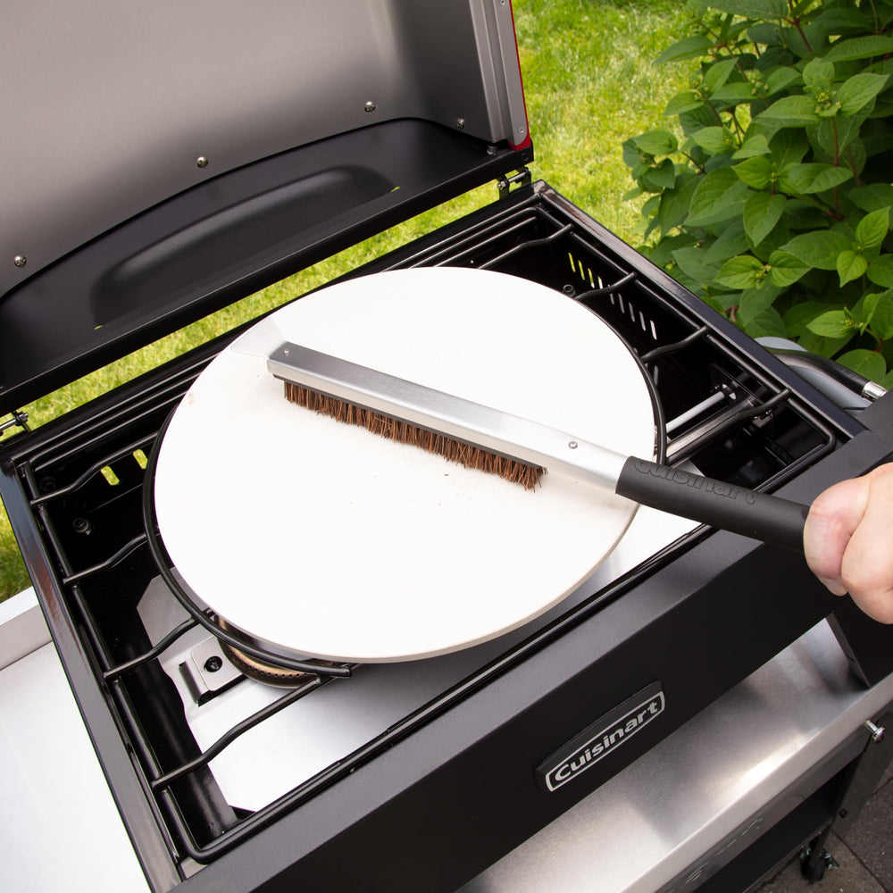 Cuisinart oven on backyard patio serving a fresh pizza, illustrating outdoor entertaining use
