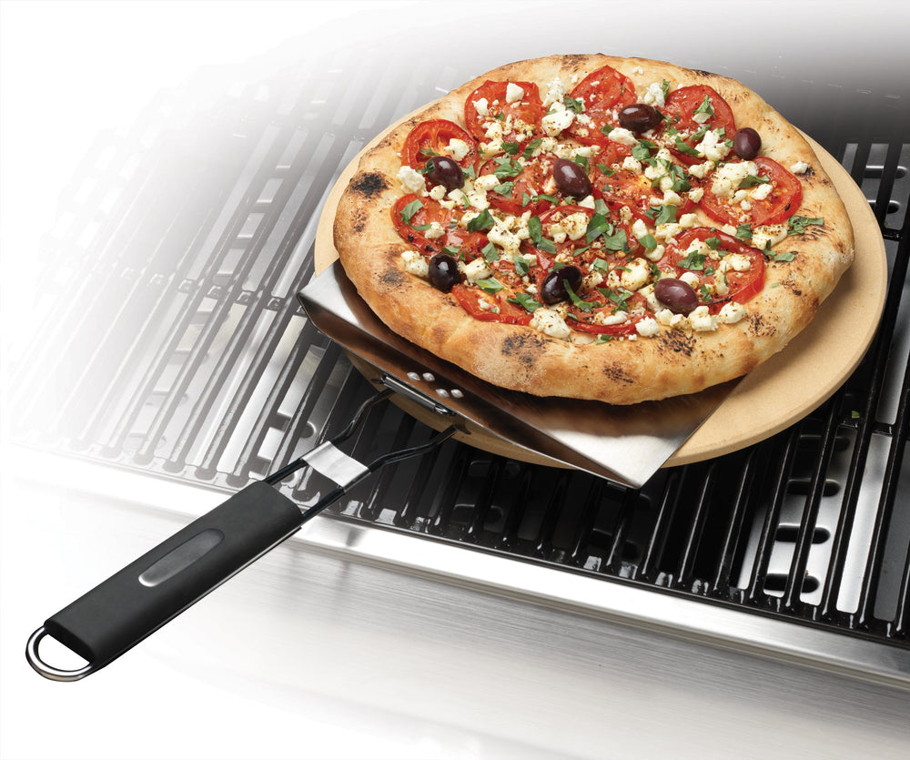 Cuisinart pizza stone beside a baking pan showing 13-inch scale and versatile fit advantage
