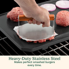 Cuisinart press flattening a patty on a hot griddle to create a caramelized crispy crust