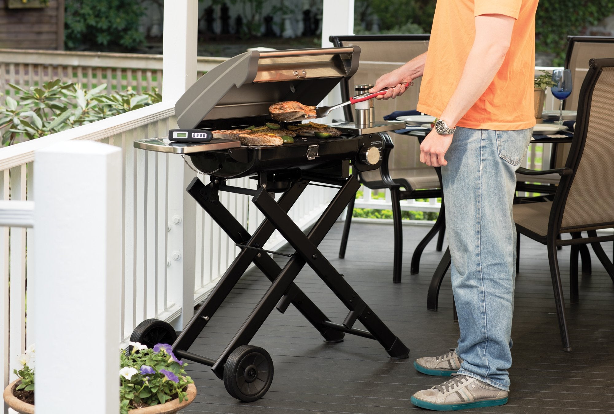 Cuisinart tools beside a hand to illustrate elongated handle length and safe distance from flames