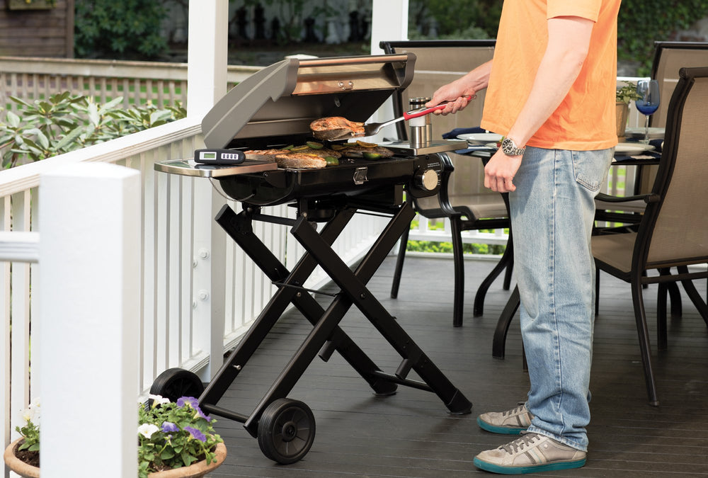 Cuisinart tools beside a hand to illustrate elongated handle length and safe distance from flames