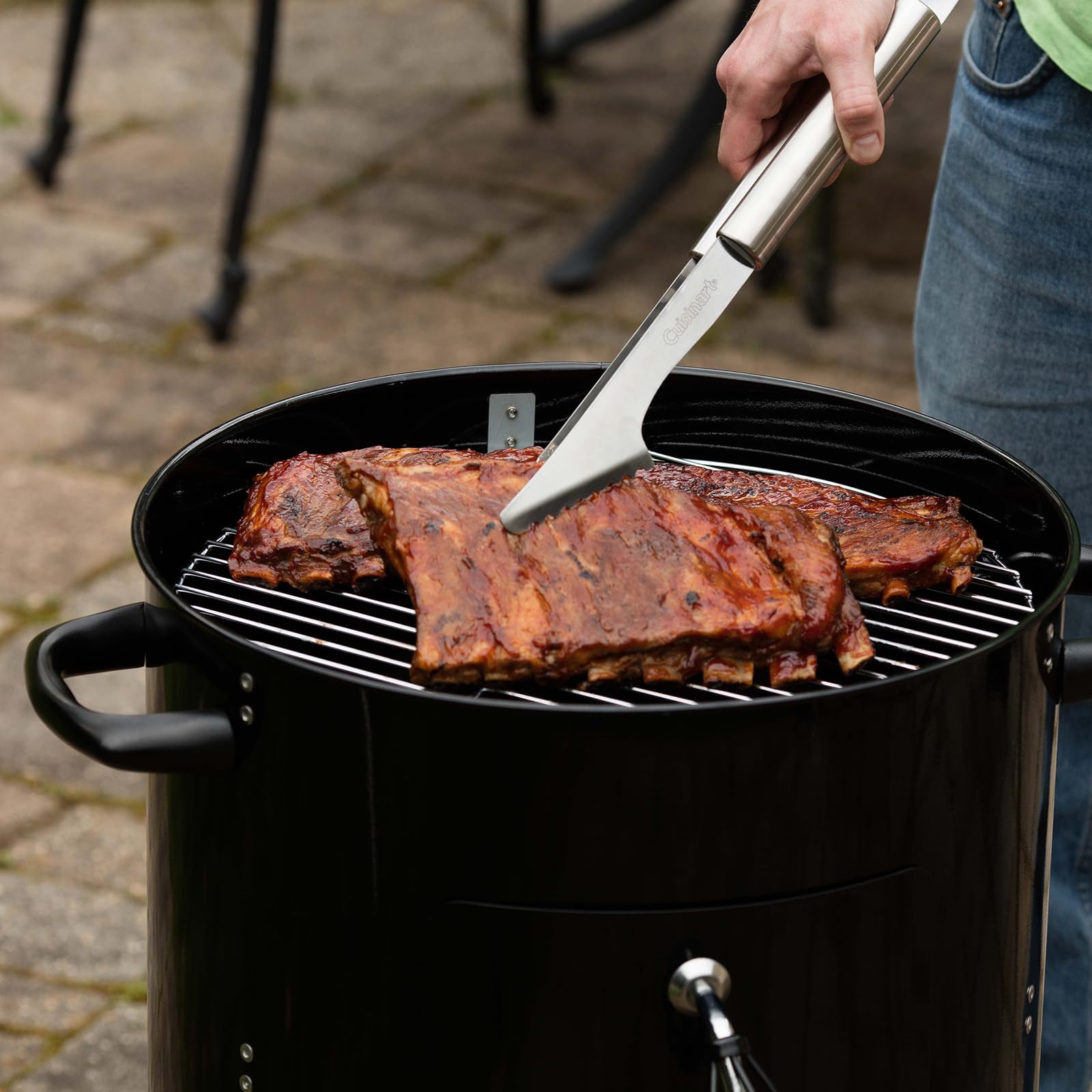 Cuisinart smoker on patio next to chair demonstrating compact footprint