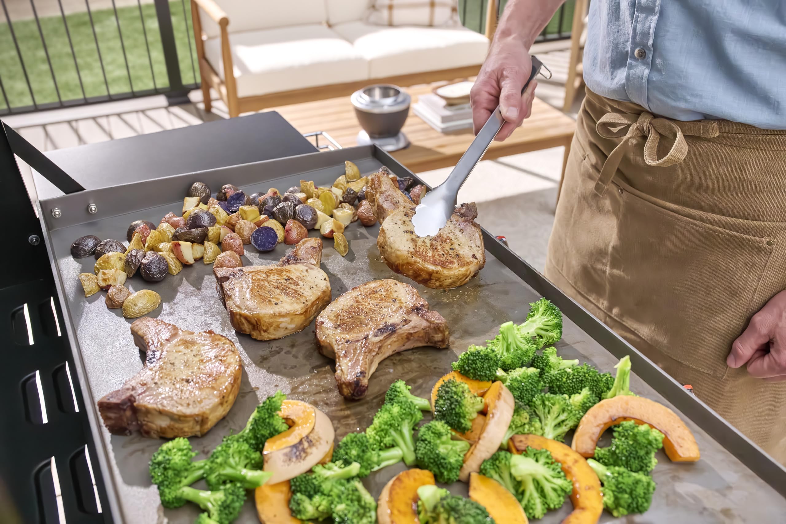 Cuisinart tongs and round turner handling food on flat top