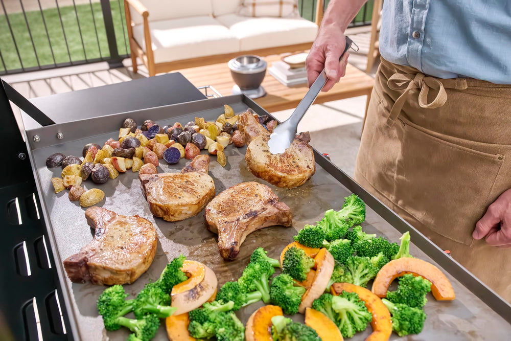 Cuisinart tongs and round turner handling food on flat top