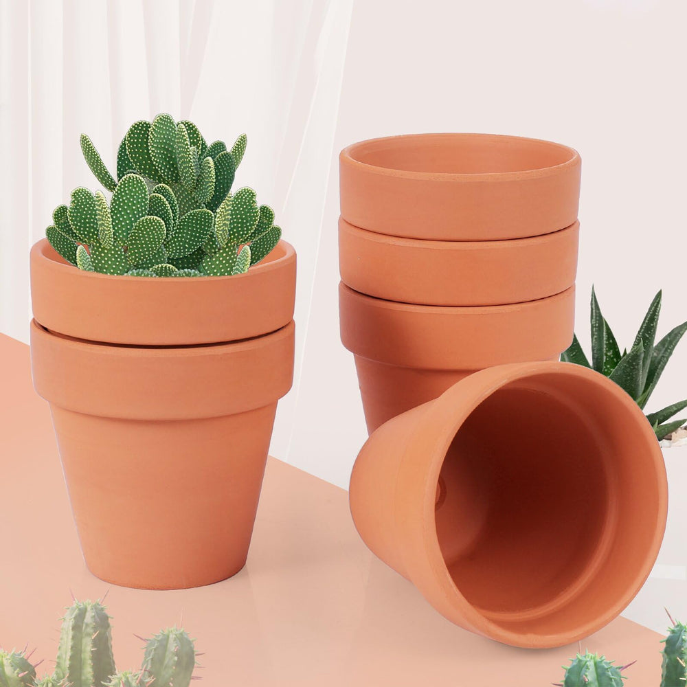 CUZZME pot held in hand showing true 6-inch scale for placement planning
