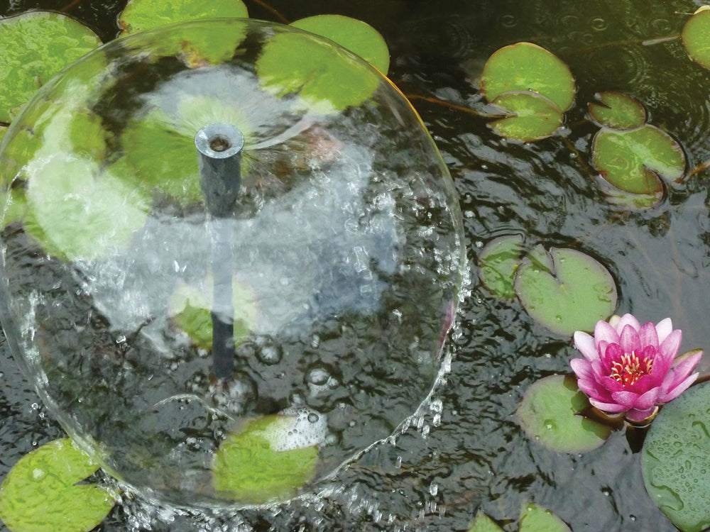 Danner bell fountain spray in pond creating soothing sound and surface movement