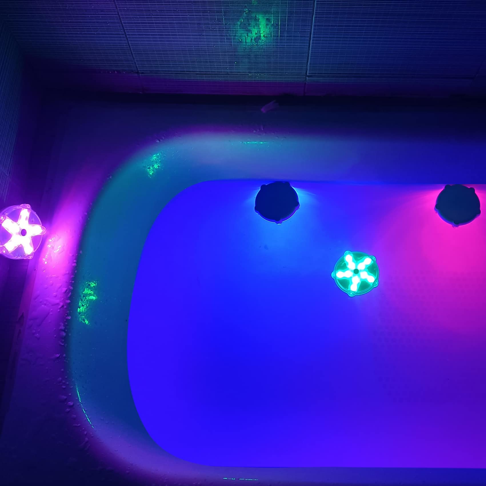 DeeprBetter floating in pool producing soft multicolor ambience for nighttime scenes
