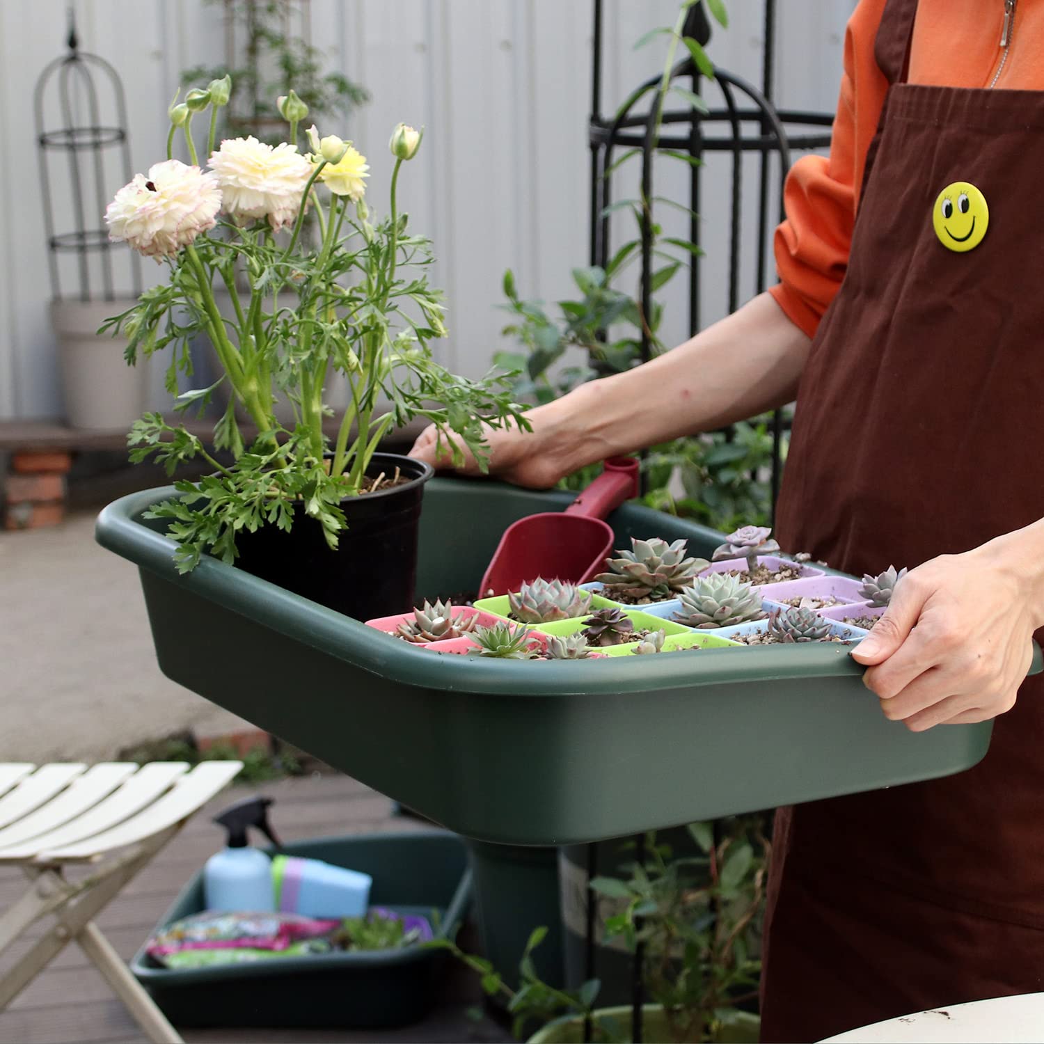 Defemim tray being used to mix potting soil, reducing mess
