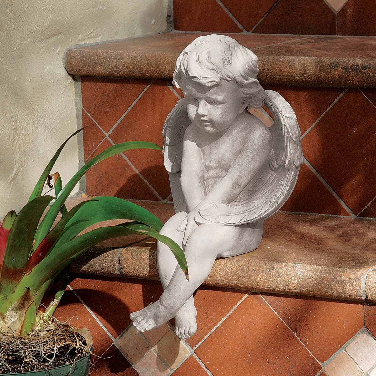 Design Toscano angel styled on a home shelf adding calm decorative accent