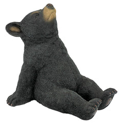 Design Toscano front view of bear cub statue showing charming posture and durable finish