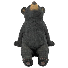 Design Toscano side profile of cub statue highlighting sculpted paws and realistic pose