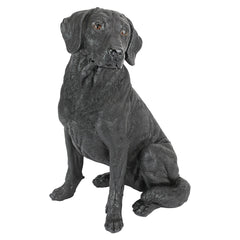 Design Toscano front view of black Labrador statue showing lifelike pose and charm