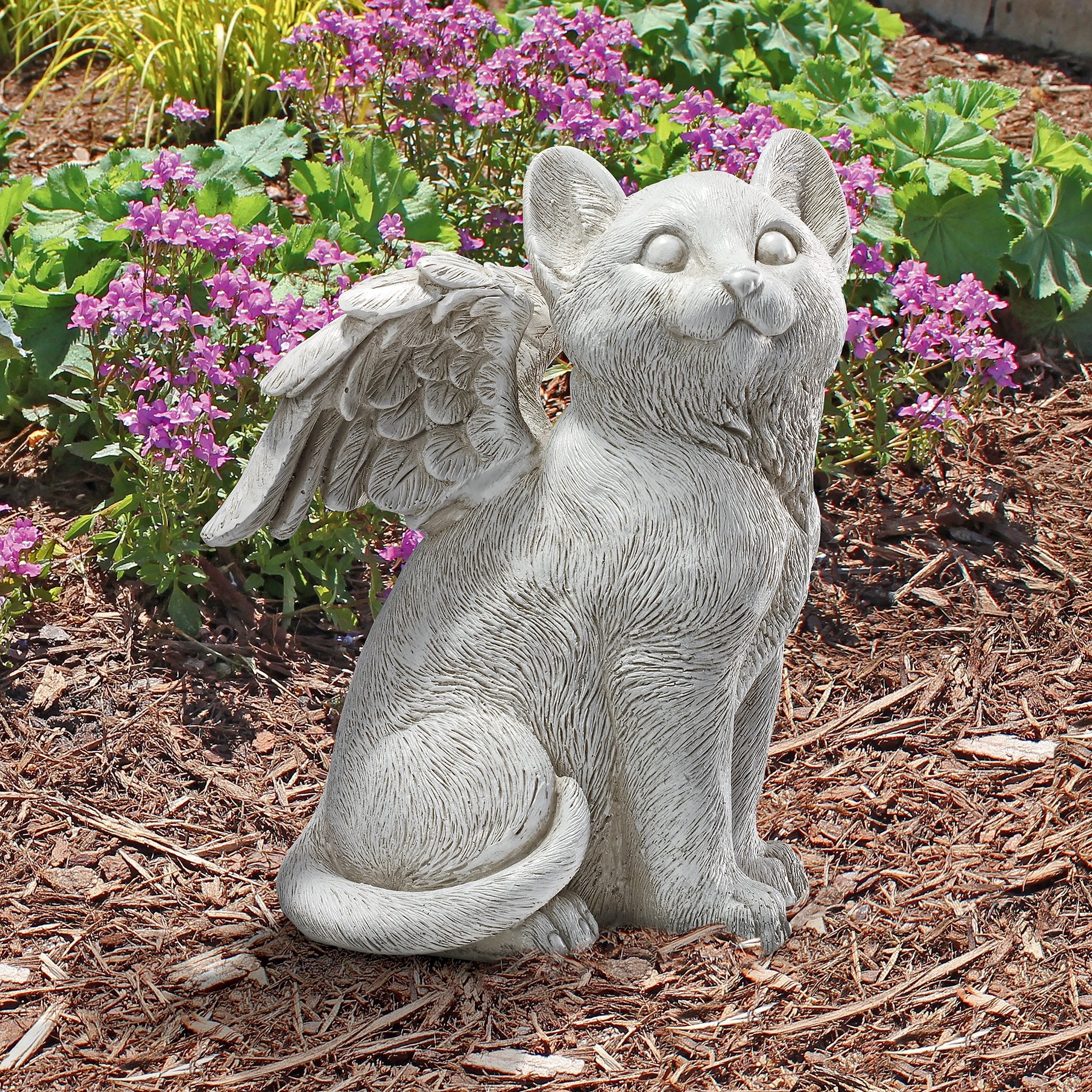 Design Toscano cat angel next to book to show compact size and scale