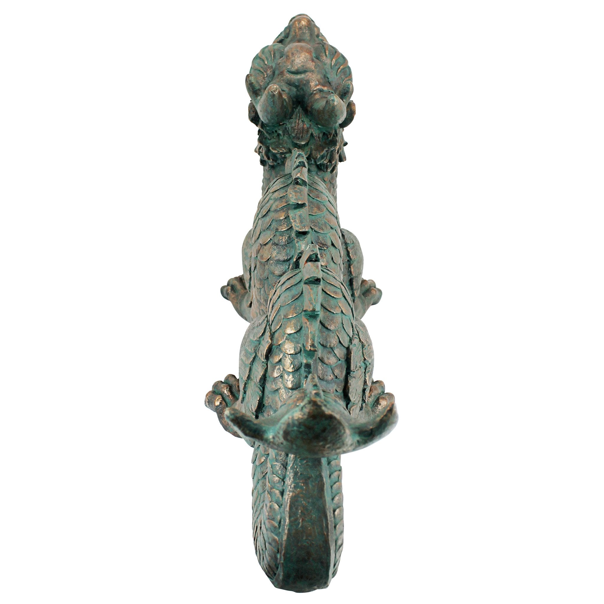 Design Toscano dragon at pond edge demonstrating waterside accent and visual balance