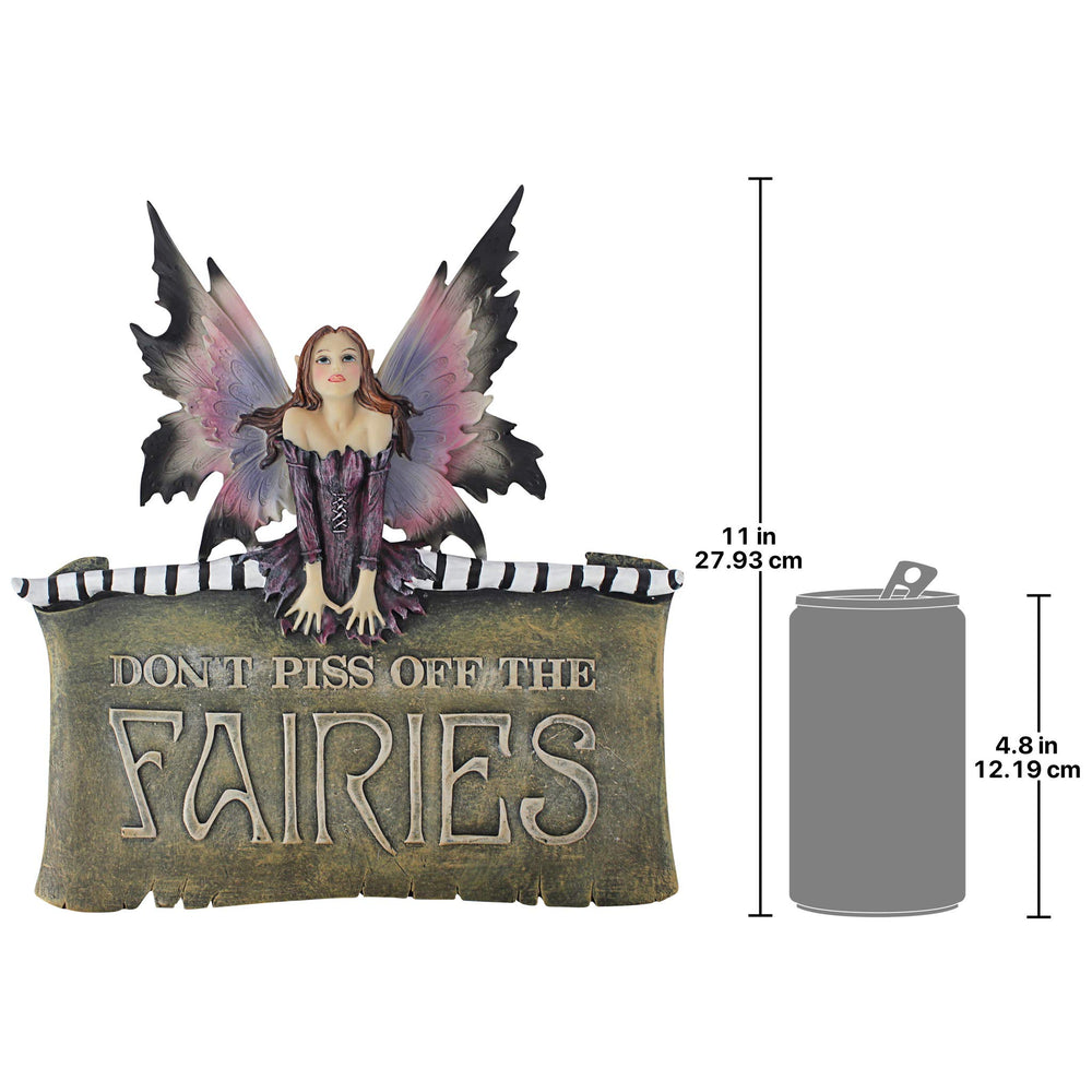 Design Toscano fairy plaque mounted on garden wall showing whimsical outdoor accent