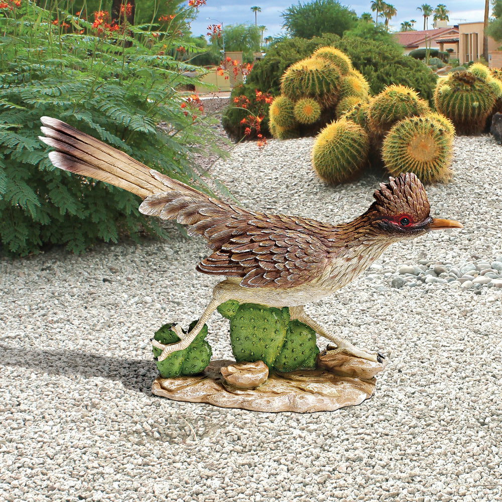 Design Toscano roadrunner next to a hand showing compact 12-inch scale