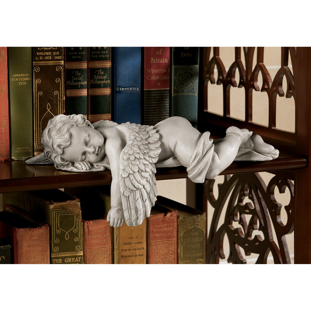 Design Toscano on bookshelf styled with books and plants adding serene home decor