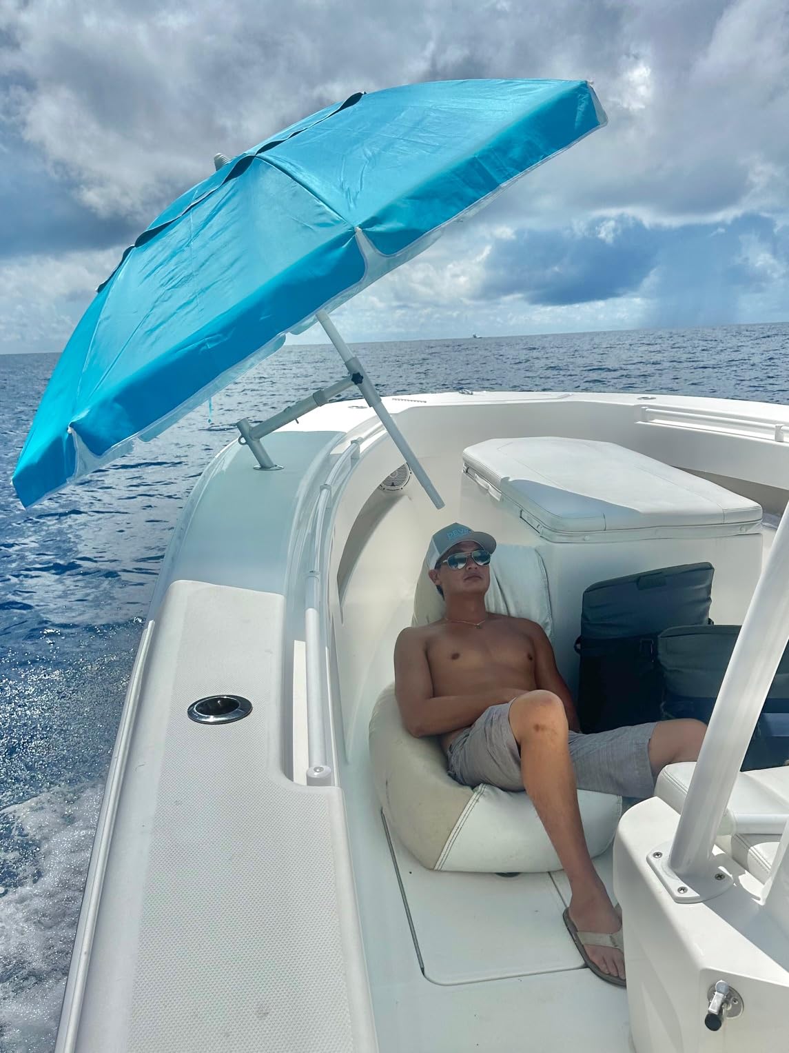 Dev Fishing mount holding umbrella over anglers providing sun protection