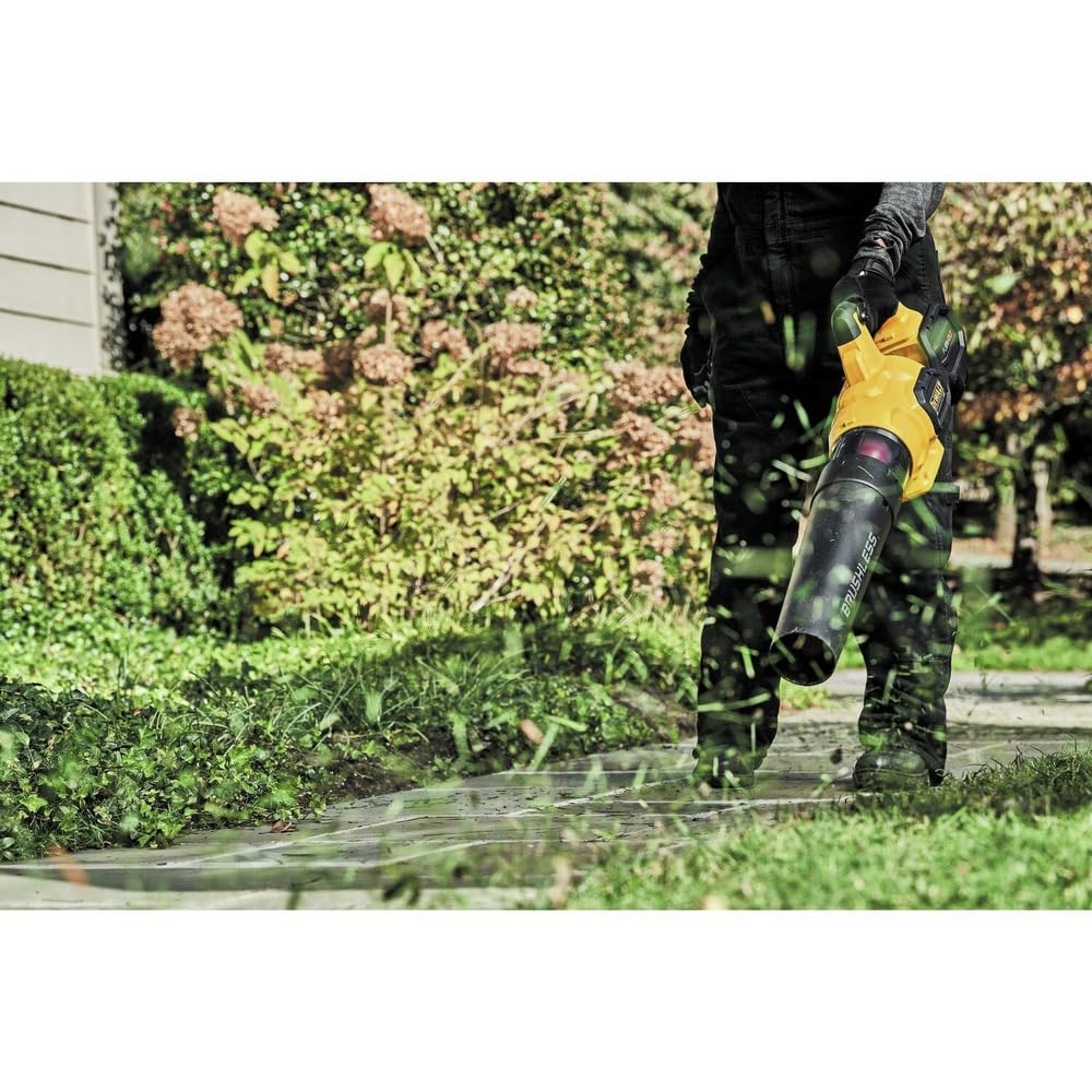 DEWALT DCBL772B in use on driveway clearing leaves, speeding yard maintenance tasks
