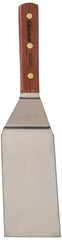Dexter rosewood handle close-up with brass rivets highlighting ergonomic comfort