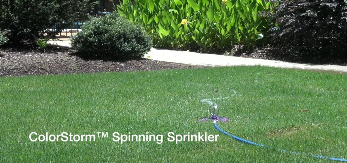 Dramm heavy-duty base detail illustrating stability on lawn for steady watering