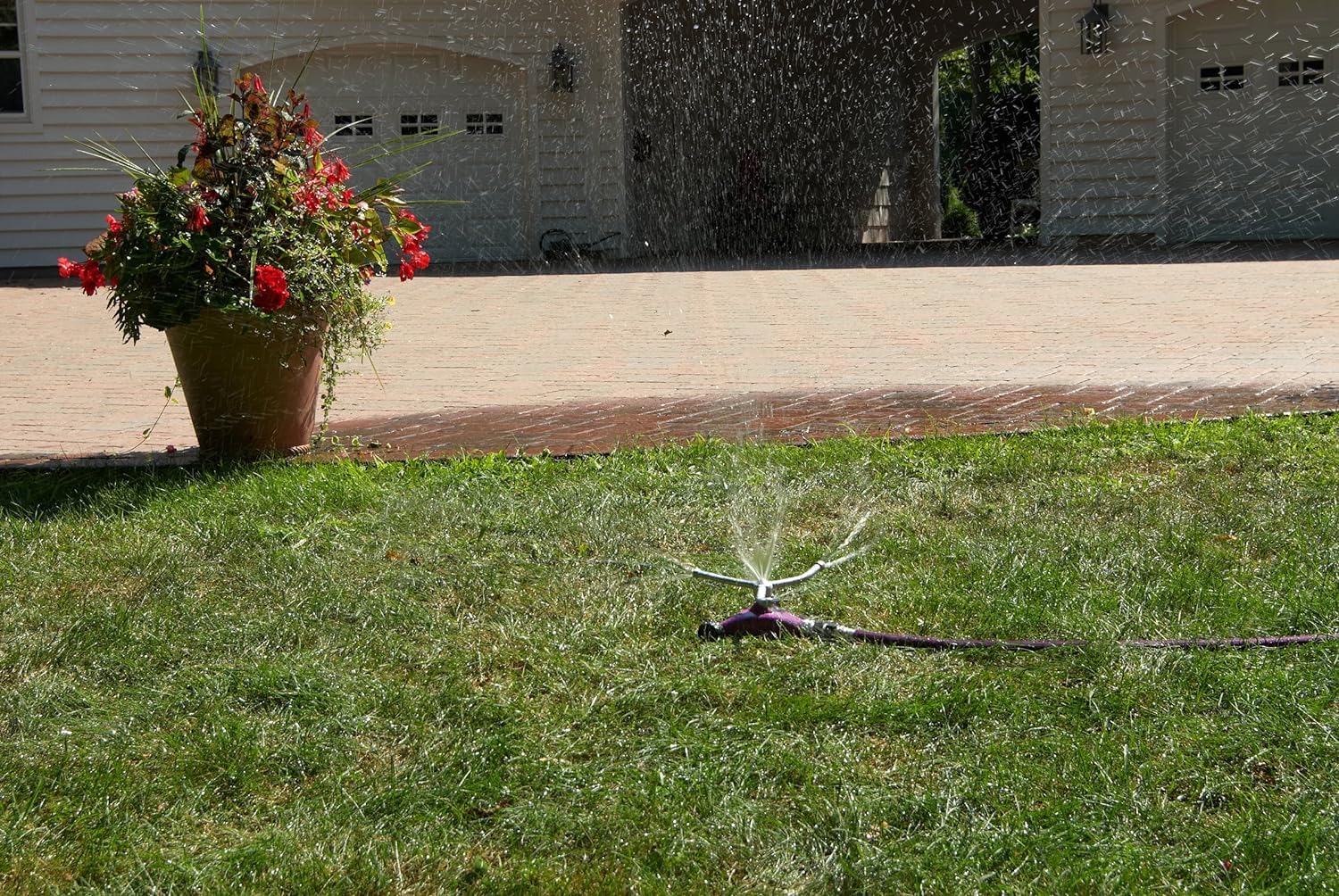 Dramm ColorStorm size comparison with hand showing compact footprint and easy maneuvering