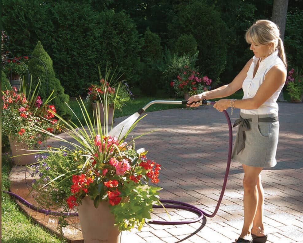 Dramm wand next to a gardener's hand showing 16-inch reach for precise container watering