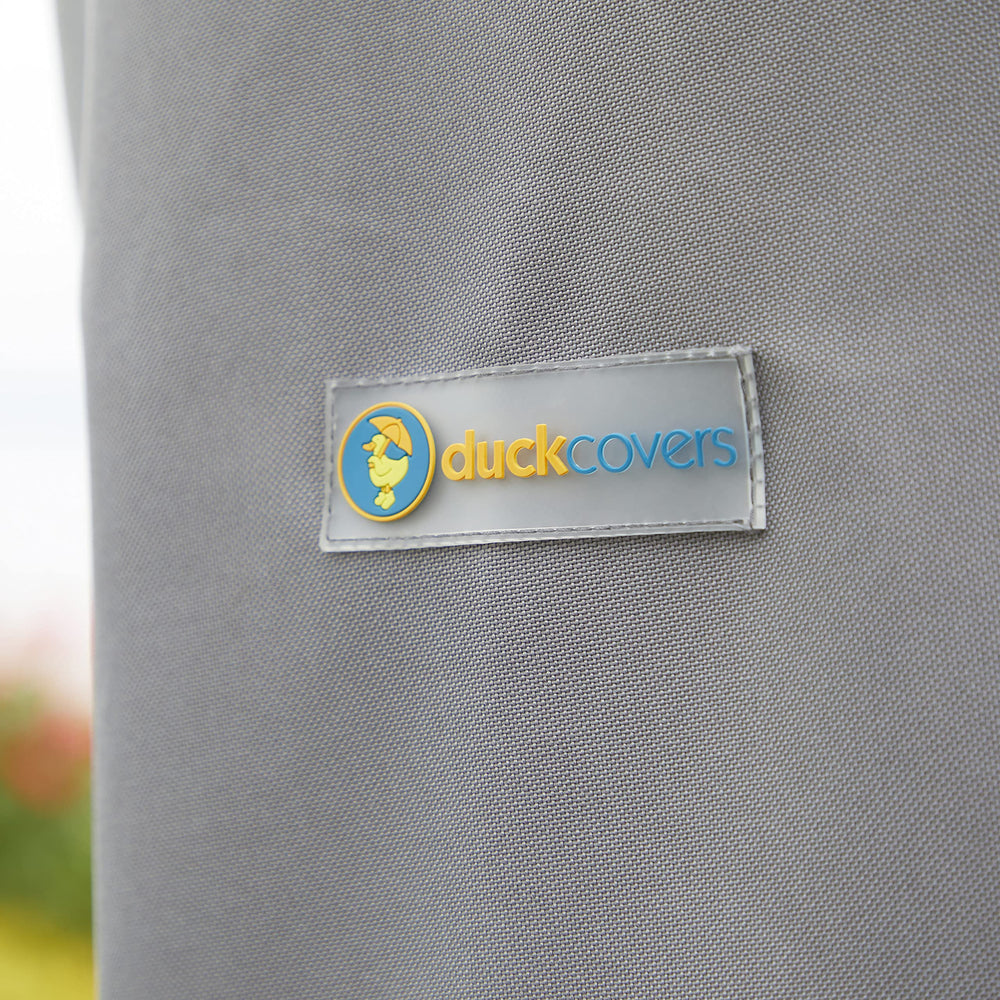 Duck Covers Soteria fitted on ottoman demonstrating weather protection in use