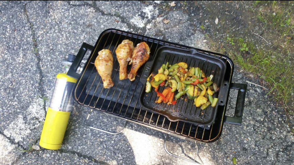 Duke Grills Omaha in use at a campsite grilling burgers with reliable heat benefit