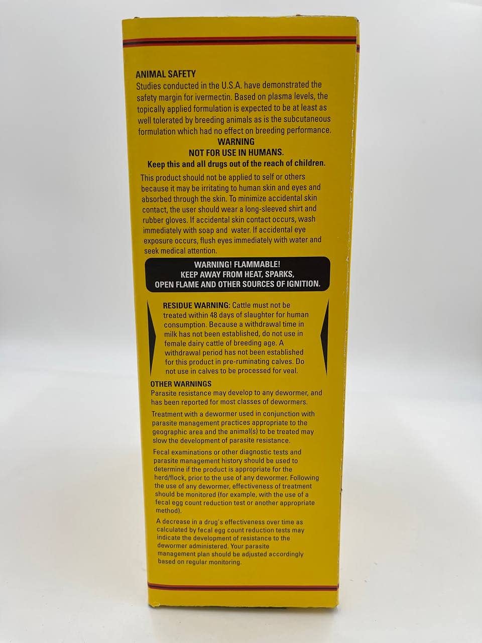 Durvet ivermectin bottle on a farm bench evoking practical on-farm parasite management